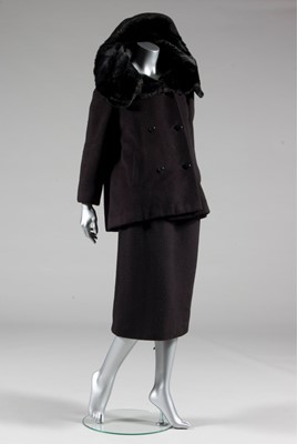 Lot 134 - A Balenciaga couture black wool suit with fur...