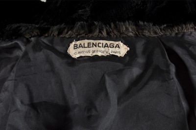 Lot 134 - A Balenciaga couture black wool suit with fur...