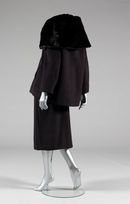 Lot 134 - A Balenciaga couture black wool suit with fur...