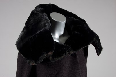 Lot 134 - A Balenciaga couture black wool suit with fur...