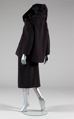 Lot 134 - A Balenciaga couture black wool suit with fur...