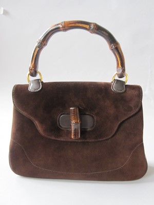 Lot 212 - A Gucci brown suede handbag with bamboo handle,...