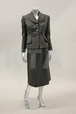 Lot 122 - A Schiaparelli grey flannel suit, early 1950s,...
