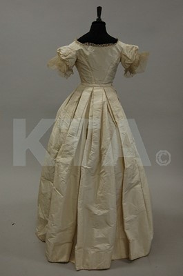 Lot 124 - An ivory taffeta bridal gown, 1850s, altered...