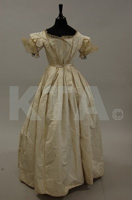 Lot 124 - An ivory taffeta bridal gown, 1850s, altered...