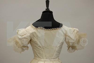 Lot 124 - An ivory taffeta bridal gown, 1850s, altered...