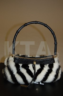 Lot 17 - A Gucci striped mink and ostrich leather bag,...