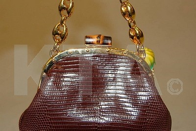 Lot 18 - A Gucci brown lizard purse, with chunky gilt...