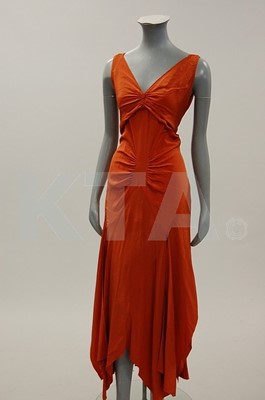 Lot 207 - A brick red crepe de chine evening gown, circa...