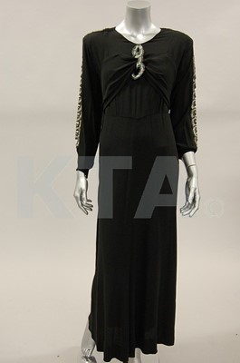 Lot 252 - Two early 1940s dresses, one of black wool...