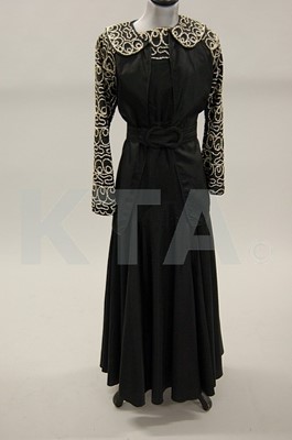 Lot 252 - Two early 1940s dresses, one of black wool...