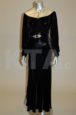 Lot 253 - A black velvet evening gown with silver lamtop...