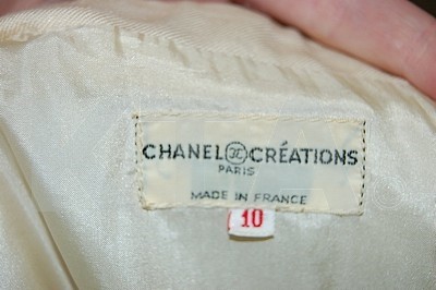 Lot 39 - A Chanel boutique cream silk suit, 1970s,...