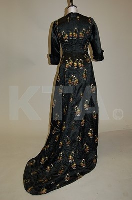 Lot 95 - An 1890s lack brocaded satin gown, woven with...