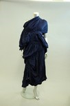 Lot 203 - A Comme des Garcons ruched navy rayon dress,...