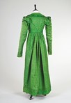 Lot 33 - An emerald green figured silk pelisse robe,...