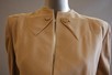 Lot 65 - An Adrian camel wool day suit, circa 1945,...