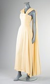 Lot 95 - A primrose yellow chiffon evening gown with...