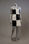 Lot 18 - A black and white chequered vinyl mini dress,...