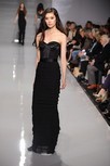 Lot 108 - A black silk strapless evening gown, with...