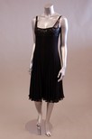 Lot 165 - Two cocktail dresses, one of pleated black...