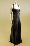 Lot 131 - A black satin halterneck evening gown, with...