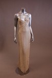 Lot 34 - A champagne silk evening gown, with silver...