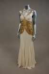 Lot 57 - A ivory chiffon and gold sequined evening gown,...