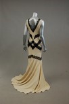 Lot 83 - A cream georgette evening gown, with black...