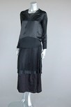 Lot 106 - A Lucien Lelong black satin dinner gown, model...