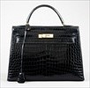 Lot 4 - An Hermès midnight blue crocodile Kelly bag,...