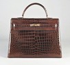 Lot 7 - A fine Hermès chocolate brown crocodile Kelly...