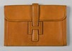 Lot 12 - An Hermès tan-brown pig-skin clutch bag,...
