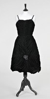 Lot 66 - A black velvet cocktail gown attributed to...
