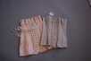 Lot 35 - Three corsets, circa 1910, comprising: an...