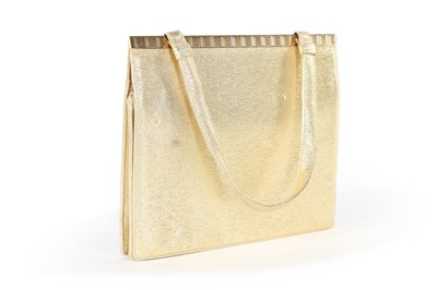 Lot 268 - A Cartier gold lurex evening bag with gold...