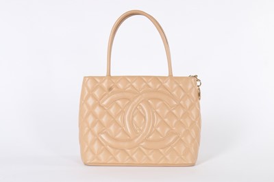 Lot 325 - A Chanel quilted beige leather shopper, 1980s,...