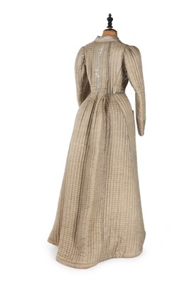 Lot 405 - A quilted and embroidered silk housecoat, 1875-...