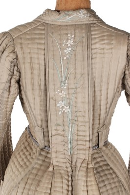 Lot 405 - A quilted and embroidered silk housecoat, 1875-...