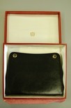 Lot 24 - A Cartier Ltd, London black pin-wheel leather...