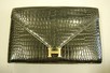 Lot 2 - An Hermès black crocodile clutch/shoulder bag,...