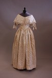 Lot 54 - An ivory damask bridal gown circa 1840, with...