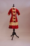 Lot 55 - A girl's dress of contrasting burgundy and...