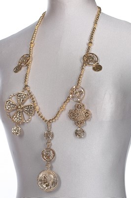 Lot 49 - An Oscar de la Renta gilt charm necklace,...