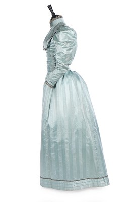 Lot 168 - A pale blue moiré evening gown, 1890s, with...