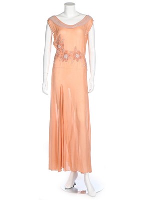 Lot 204 - A group of evening wear in peach-pink tones,...