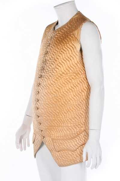 Lot 93 - Two waistcoats, one of quilted peach satin...