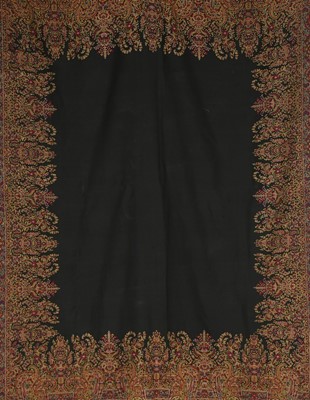 Lot 454 - A black ground long shawl, Norwich, 1840s,...