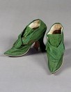 Lot 313 - A fine pair of green satin and braid trimmed...