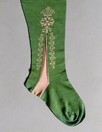 Lot 314 - A knitted green silk lady's stocking, early...